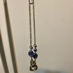Silver colored necklace with blue stones